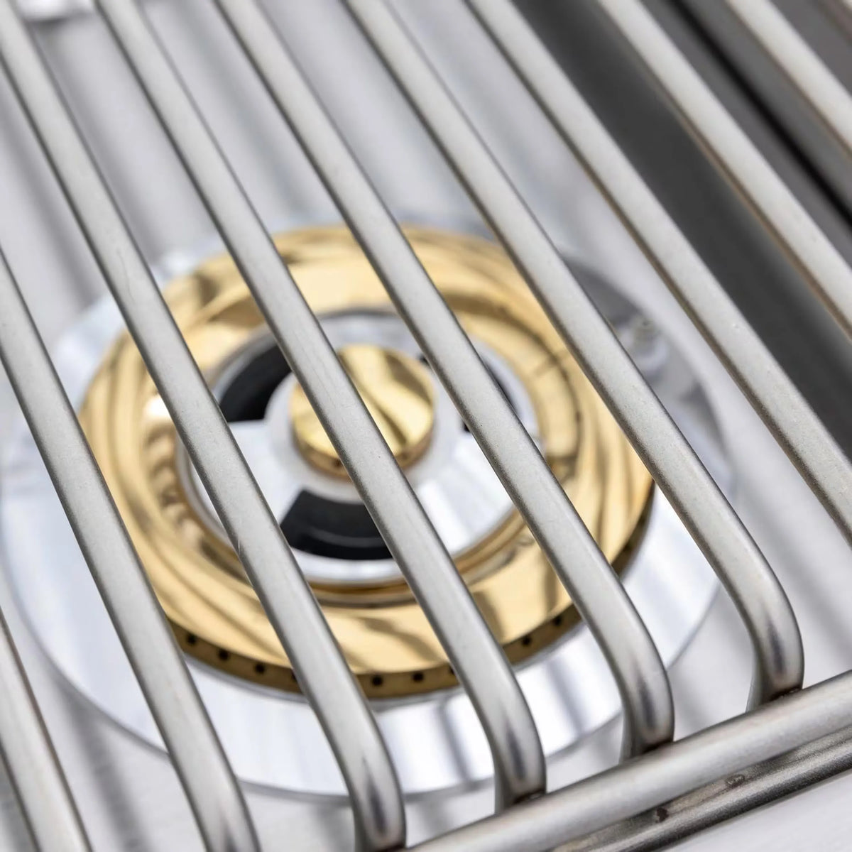 Double-burner grill burner grates with metal tubes and brass-colored ring