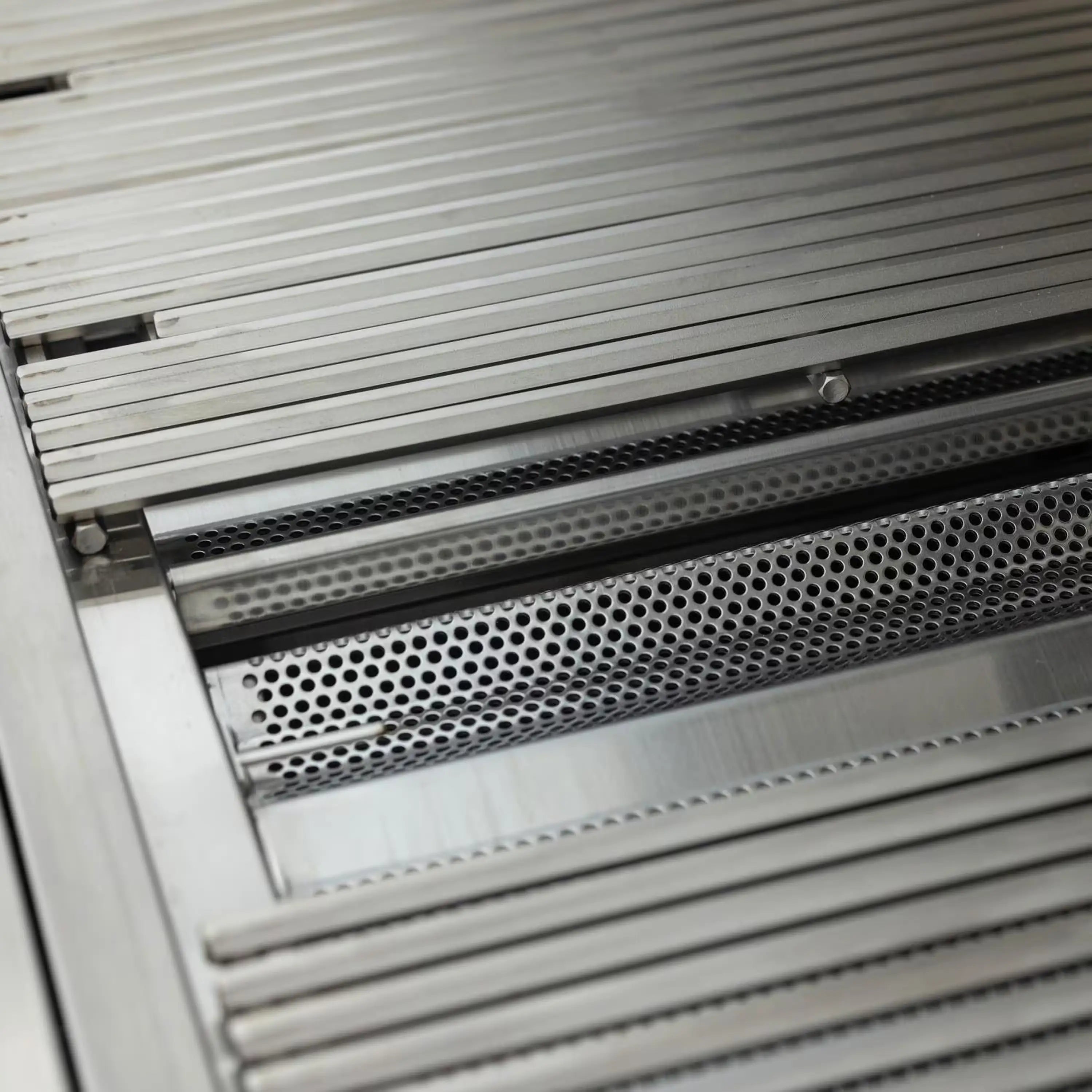 Stainless steel burner tube and perforated heat shield with ignition access