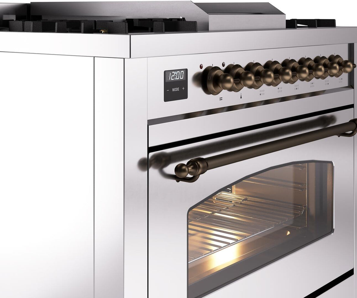 Stainless steel dual fuel range side close-up with bronze control knobs and oven window
