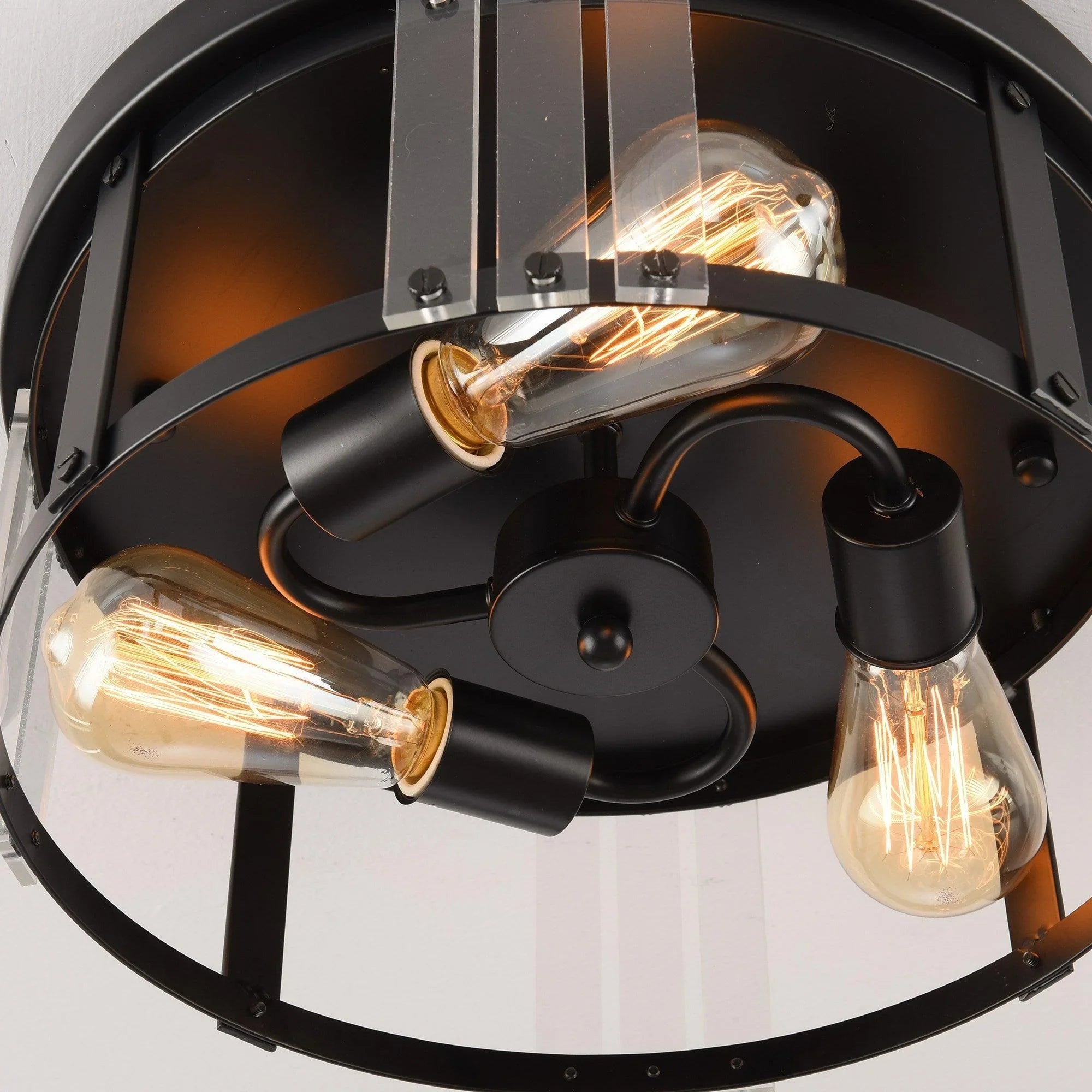 Interior view of black 3-light flush mount with three exposed bulbs and curved metal arms