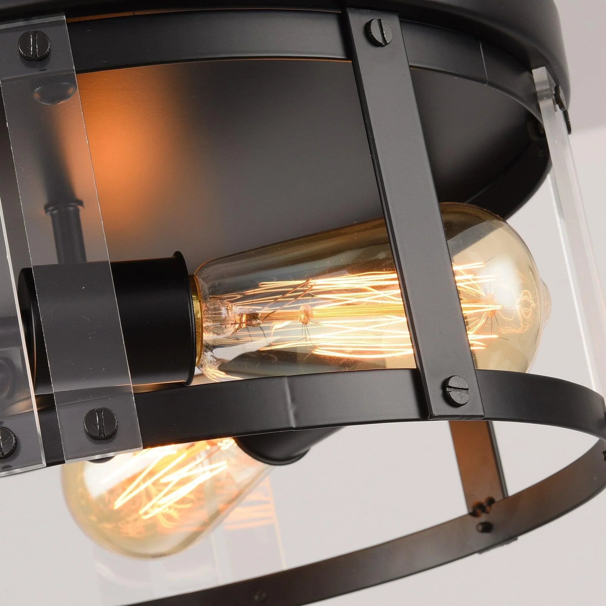 Close-up of black flush mount ceiling light showing clear bulb glass and metal bars