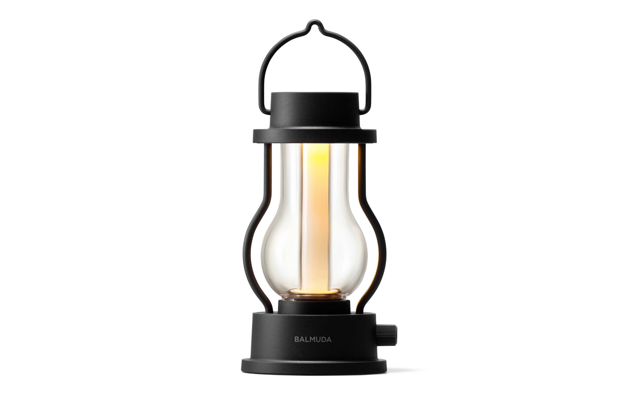 BALMUDA rechargeable LED lantern in black with handle and glowing glass body