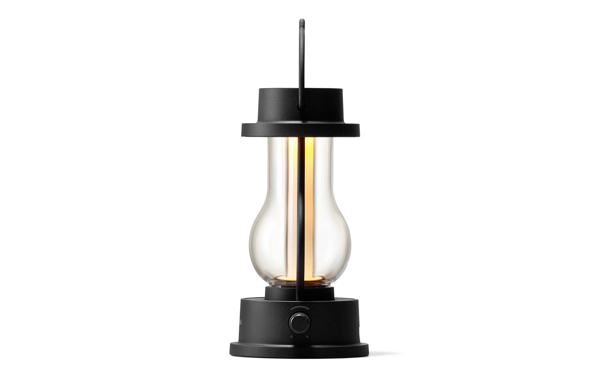 Rechargeable LED lantern in black with top handle, glowing glass and side control