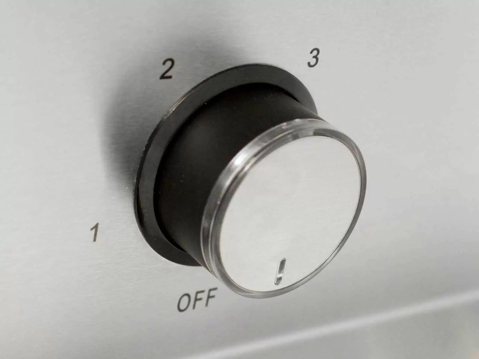 Round stainless vent hood dial knob with OFF marking and metal trim ring