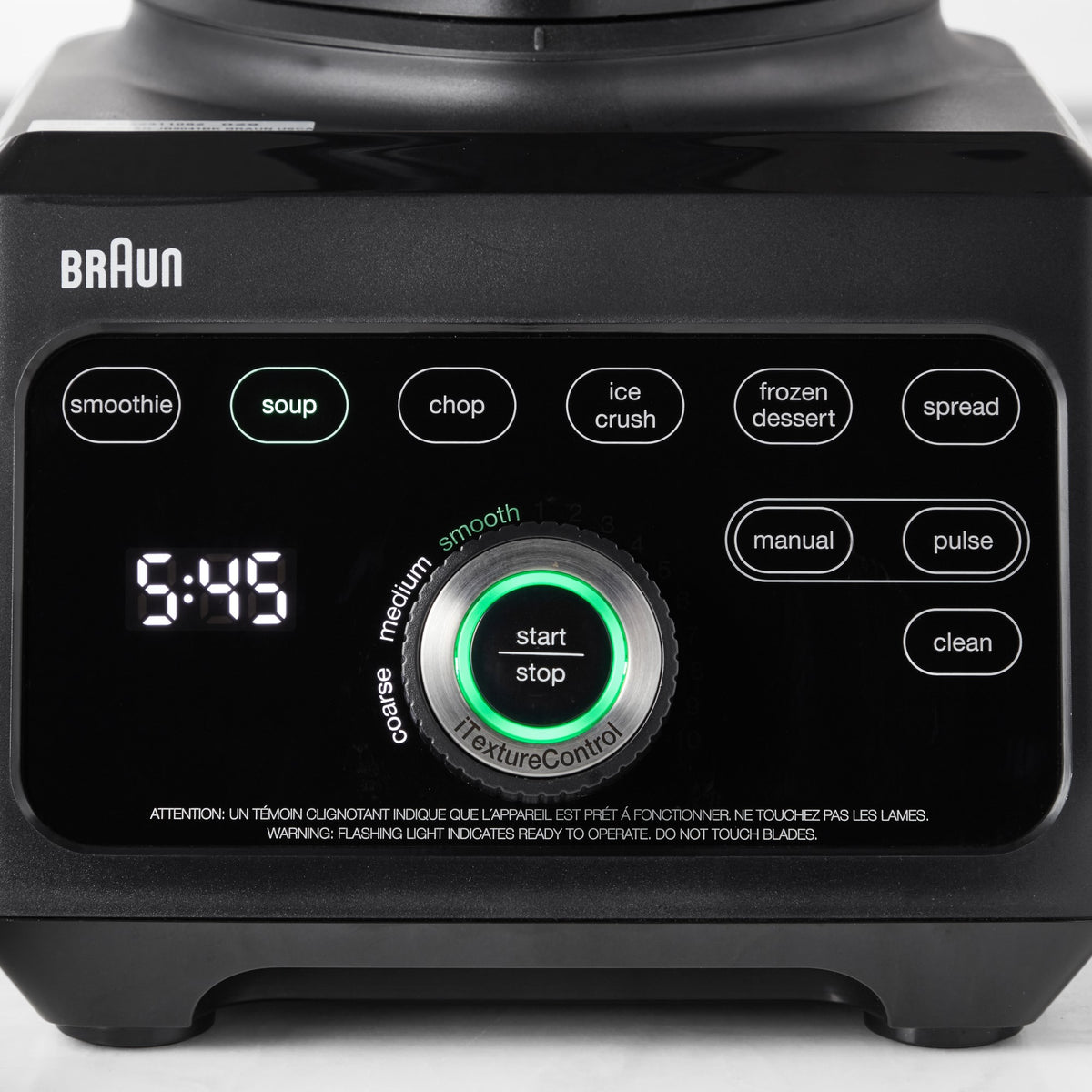 Braun black blender control panel close-up with program buttons and green dial.