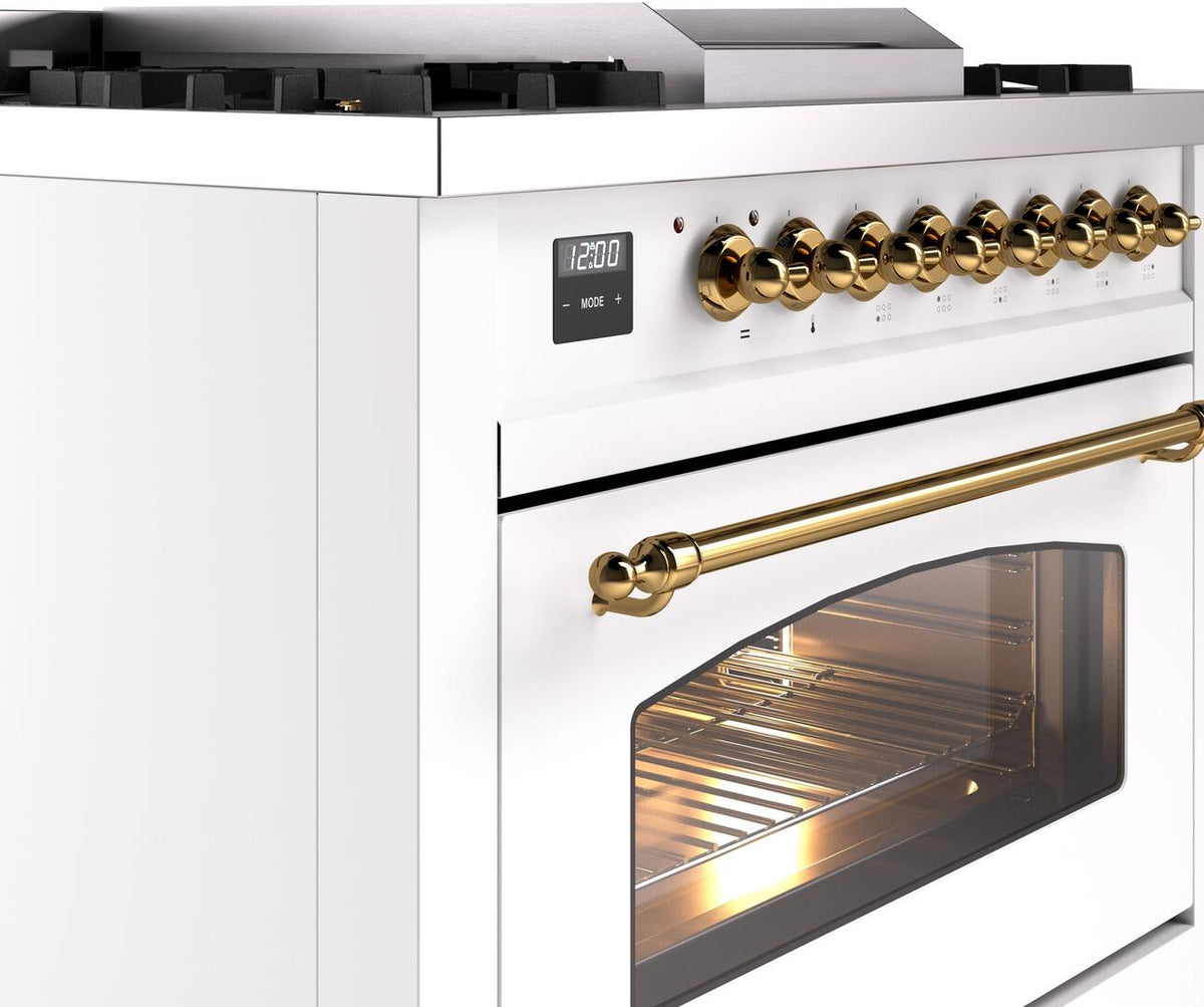 Freestanding range control panel with brass knobs and large brass oven handle