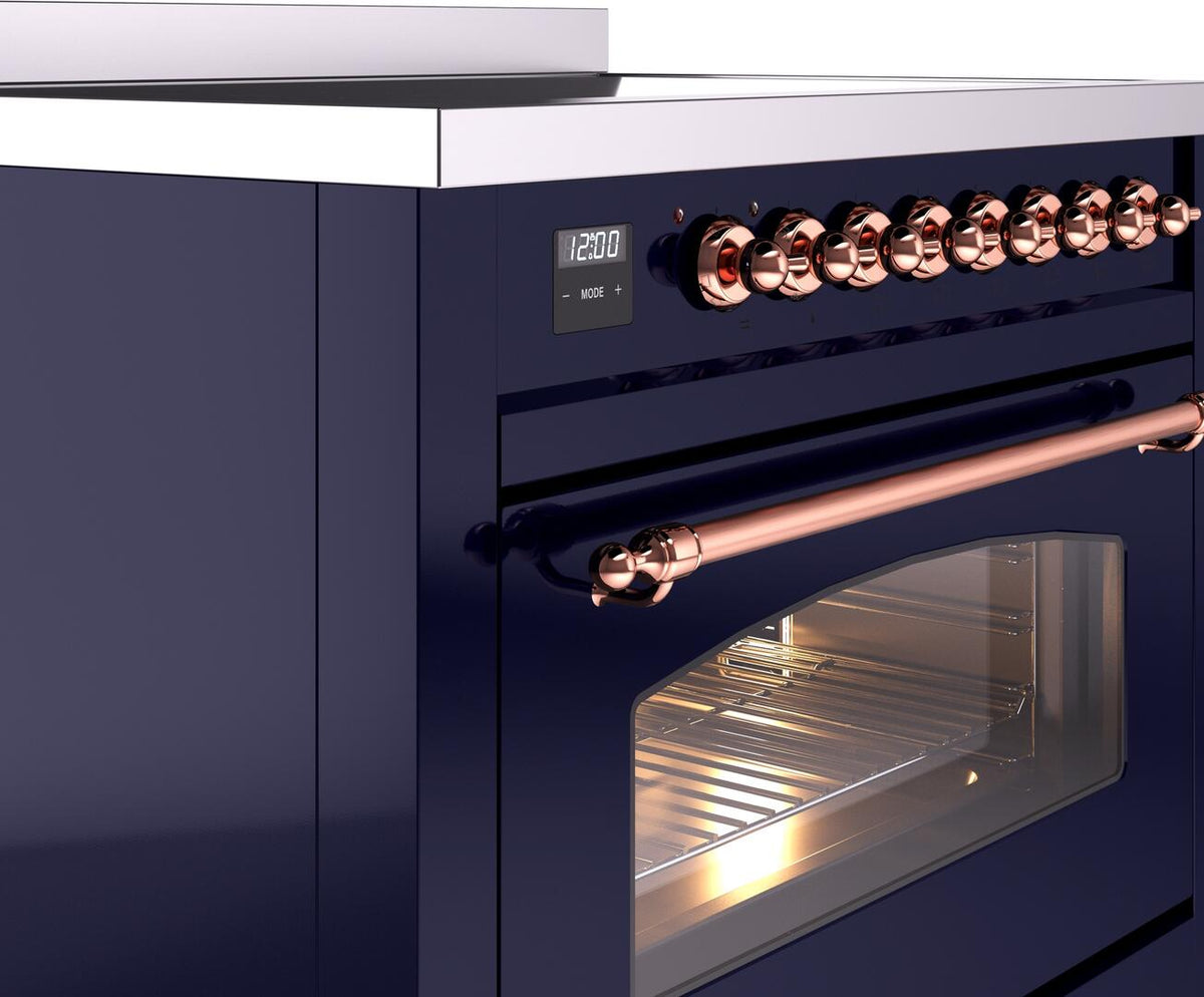 Control panel with copper knobs and display above a glass-front oven on a range