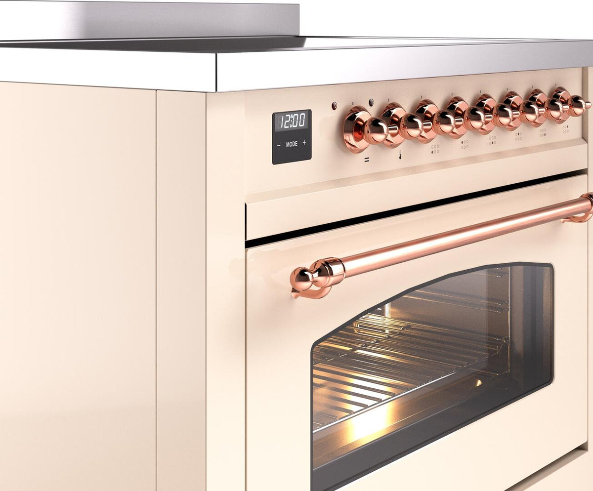 Freestanding induction range front corner with copper control knobs and glass oven door