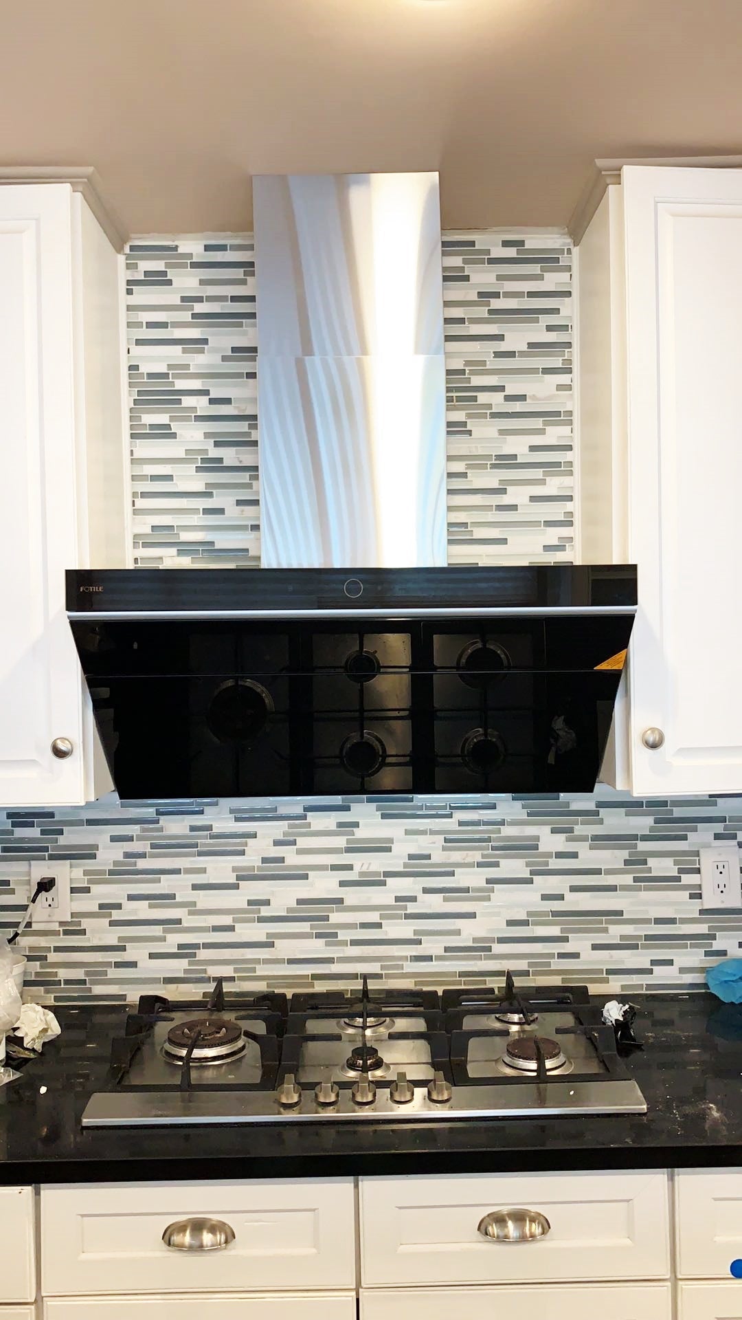Stainless steel ceiling vent cover chimney above range hood in kitchen