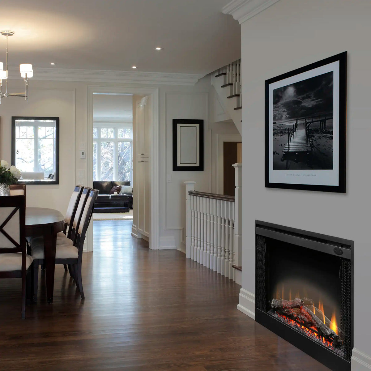 Black electric fireplace insert with glass front, flames and embers visible
