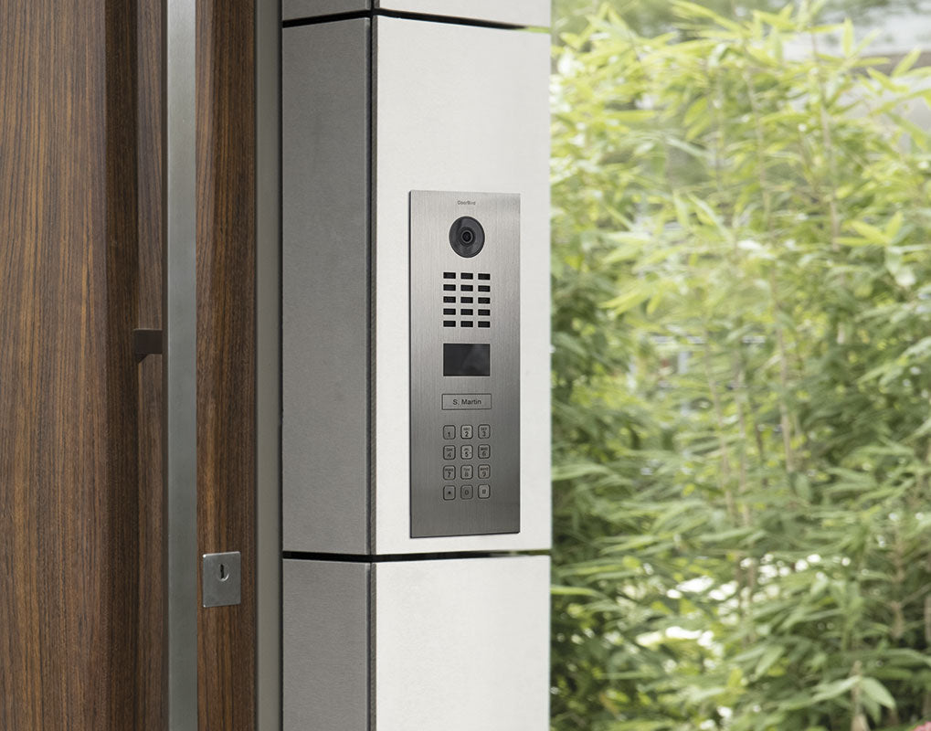 Titanium door intercom panel with camera lens and numeric keypad in trim
