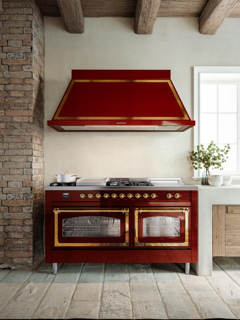 Antique white and copper-trimmed dual oven range with six burners and hood