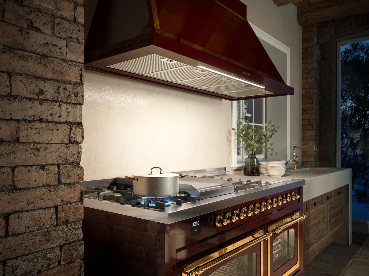 Dual fuel range with stainless griddle surface, burners, and warm interior glow through doors