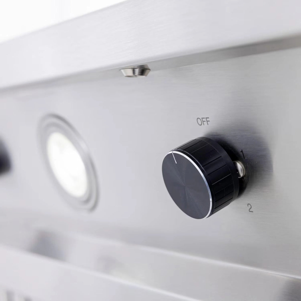 Outdoor vent hood control panel with OFF label and black rotary knob