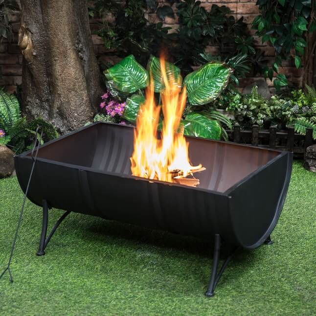 Black barrel firepit with wood-burning flames and arched firebox opening
