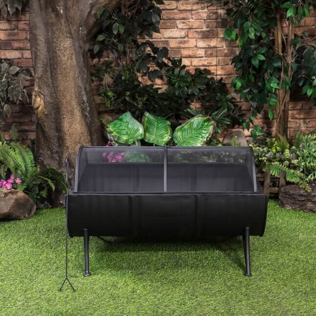 Barrel firepit with legs and raised front mesh spark screen for burning logs