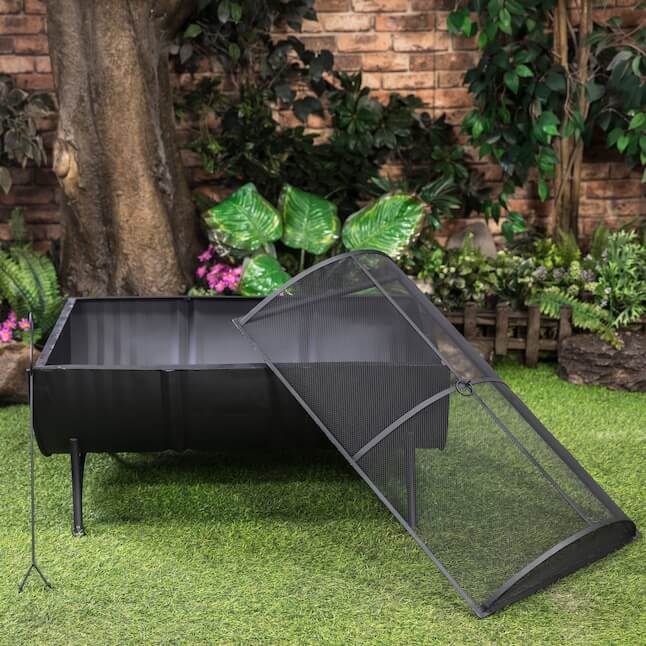Black barrel firepit with hinged mesh spark screen set open at an angle