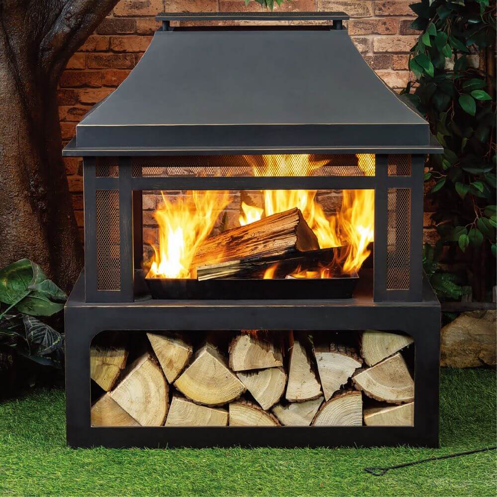 Black metal wood burner fireplace with open firebox and front log storage