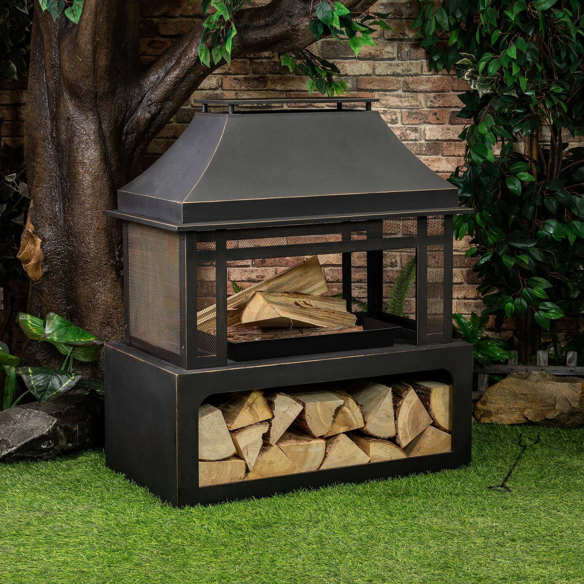 Black metal wood burner fireplace with sloped hood and stacked log compartment