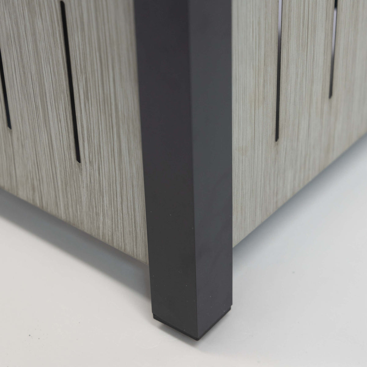 Rectangular firetable with black legs and light wood slatted cabinet side panel