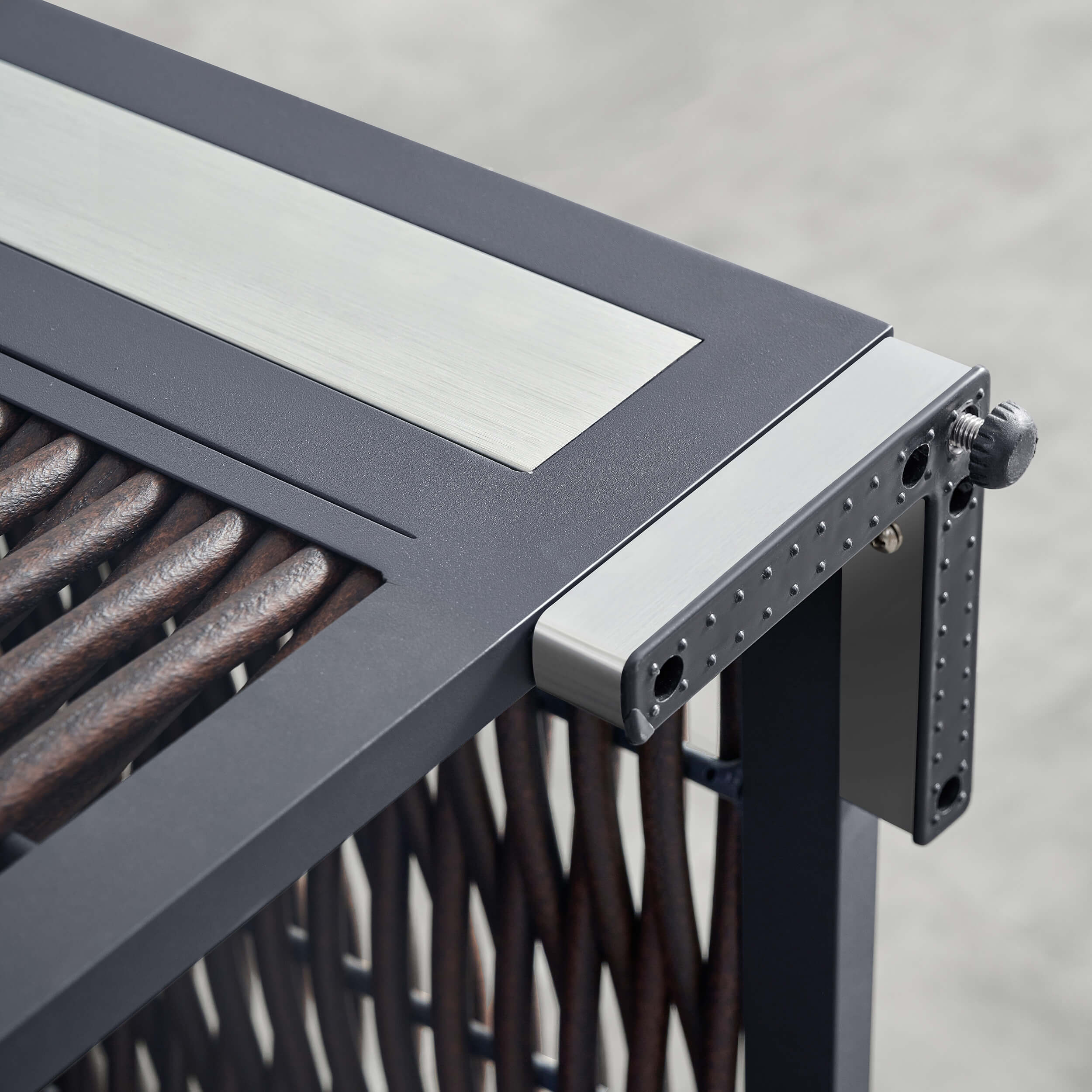 Dark metal firepit lid hinge and burner rods detail