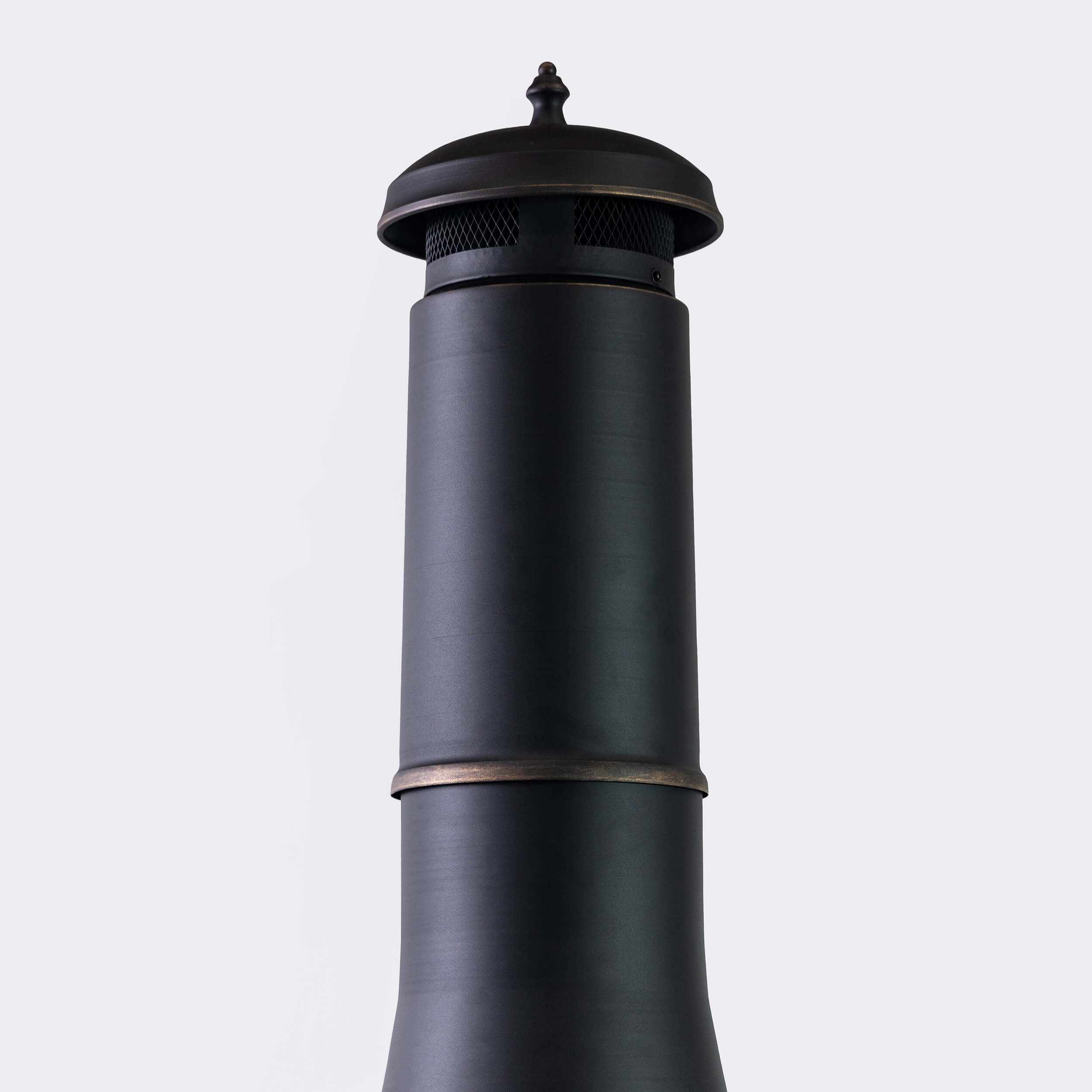 Top view of chimney wood burner with round cap on dark metal stack