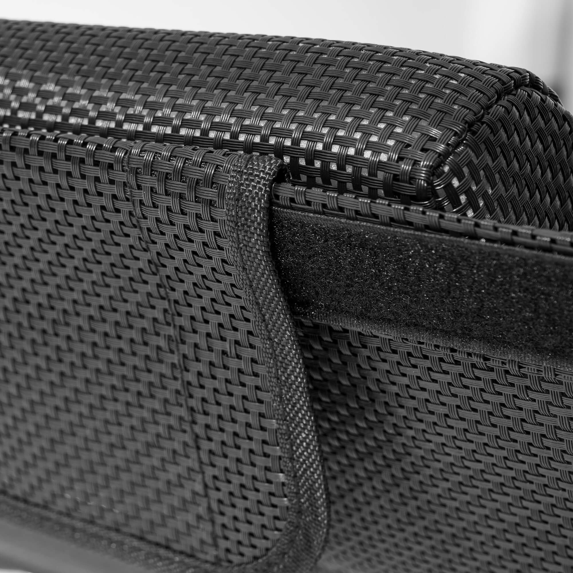 Woven dark gray side panel with cushioned backrest on outdoor lounge daybed