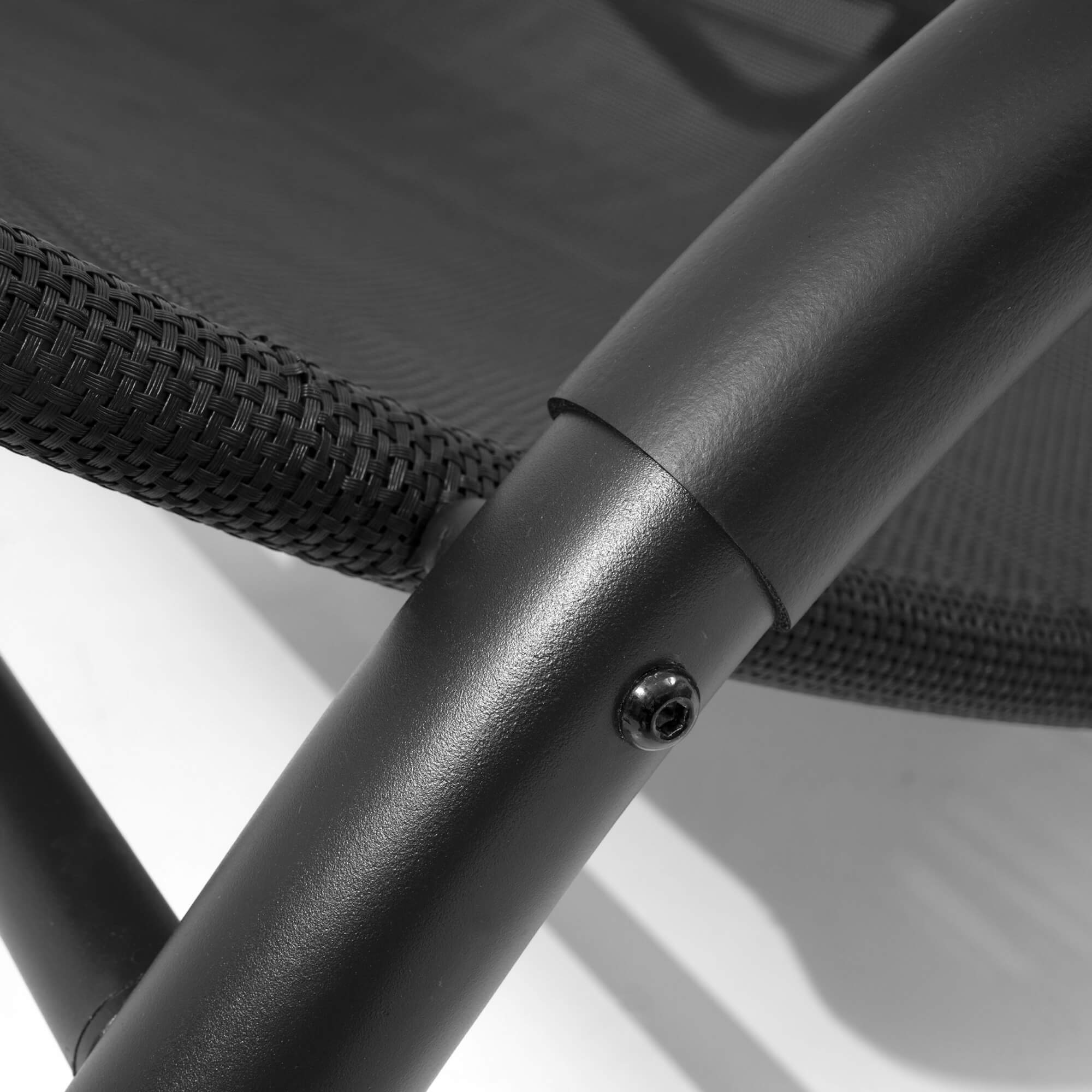 Black metal arm support with screw and woven fabric weave detail on lounge daybed
