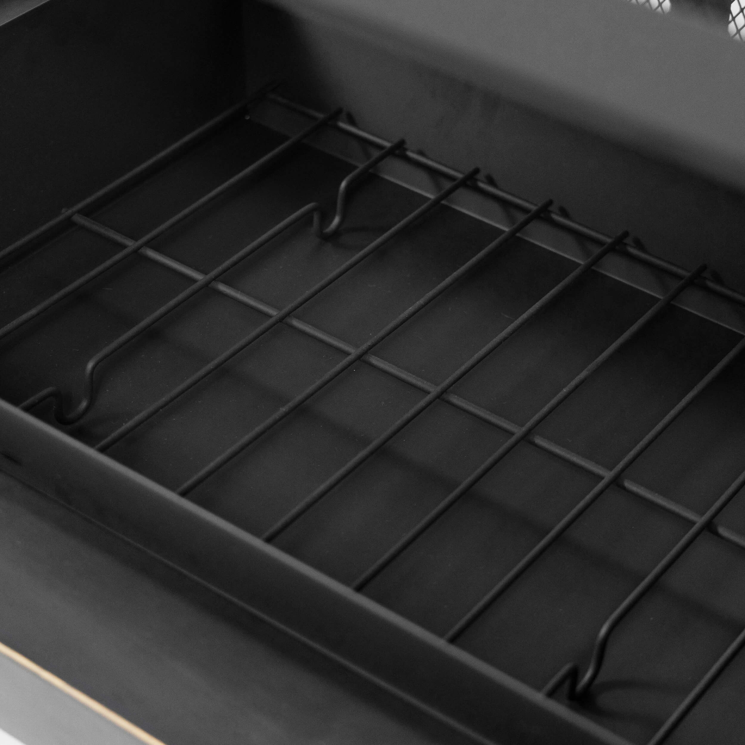 Metal firebox base with grid grate and side air-vent channels