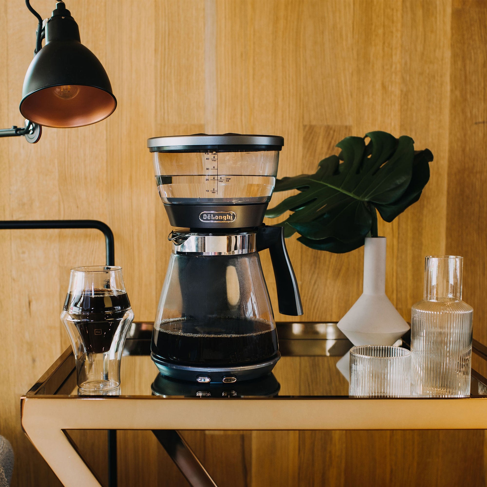 Stainless 3-in-1 coffee brewer on countertop with glass cups for serving