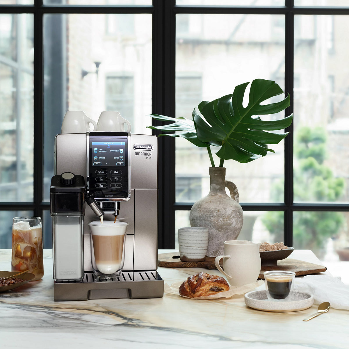 Titanium De'Longhi super-automatic coffee machine with automatic milk frother and control panel