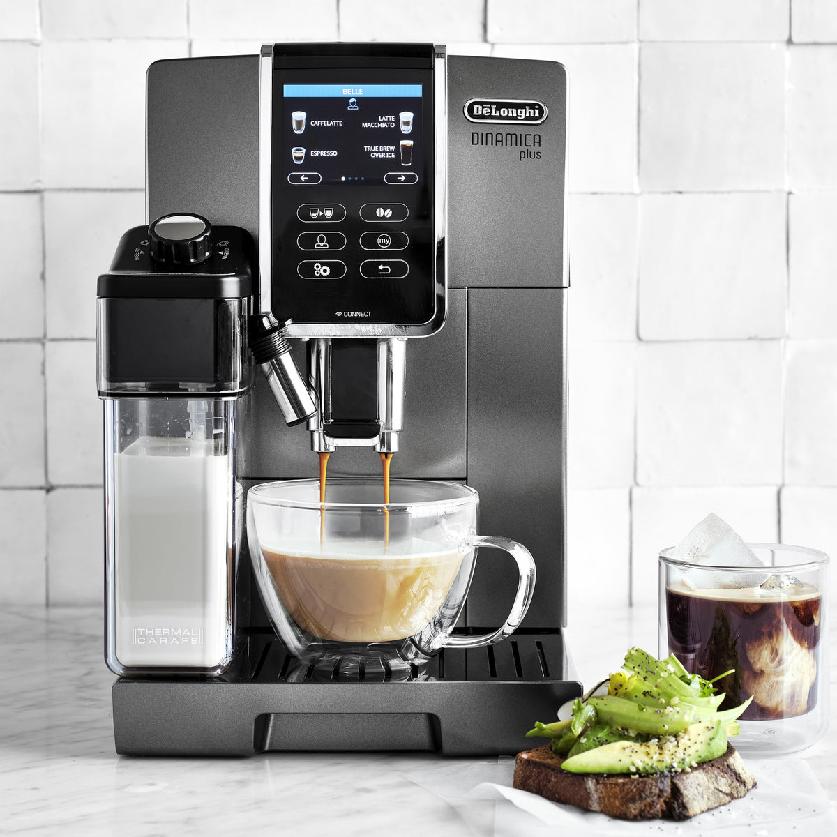 Titanium super automatic coffee machine dispensing espresso into a mug with milk frother
