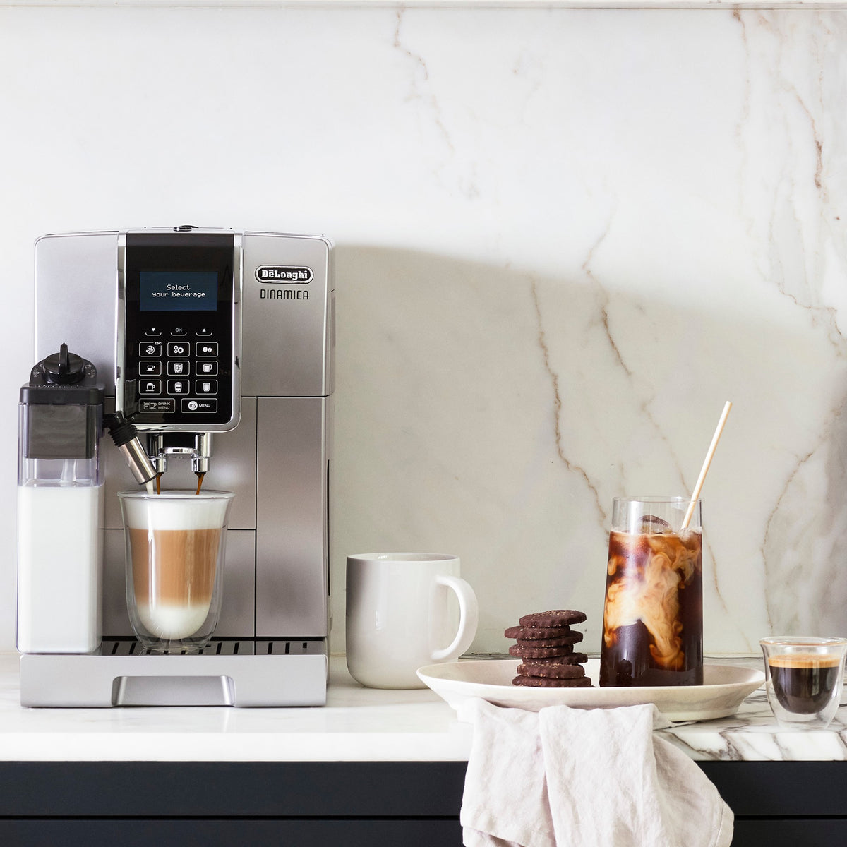Silver espresso machine beside mugs and glasses with coffee drinks