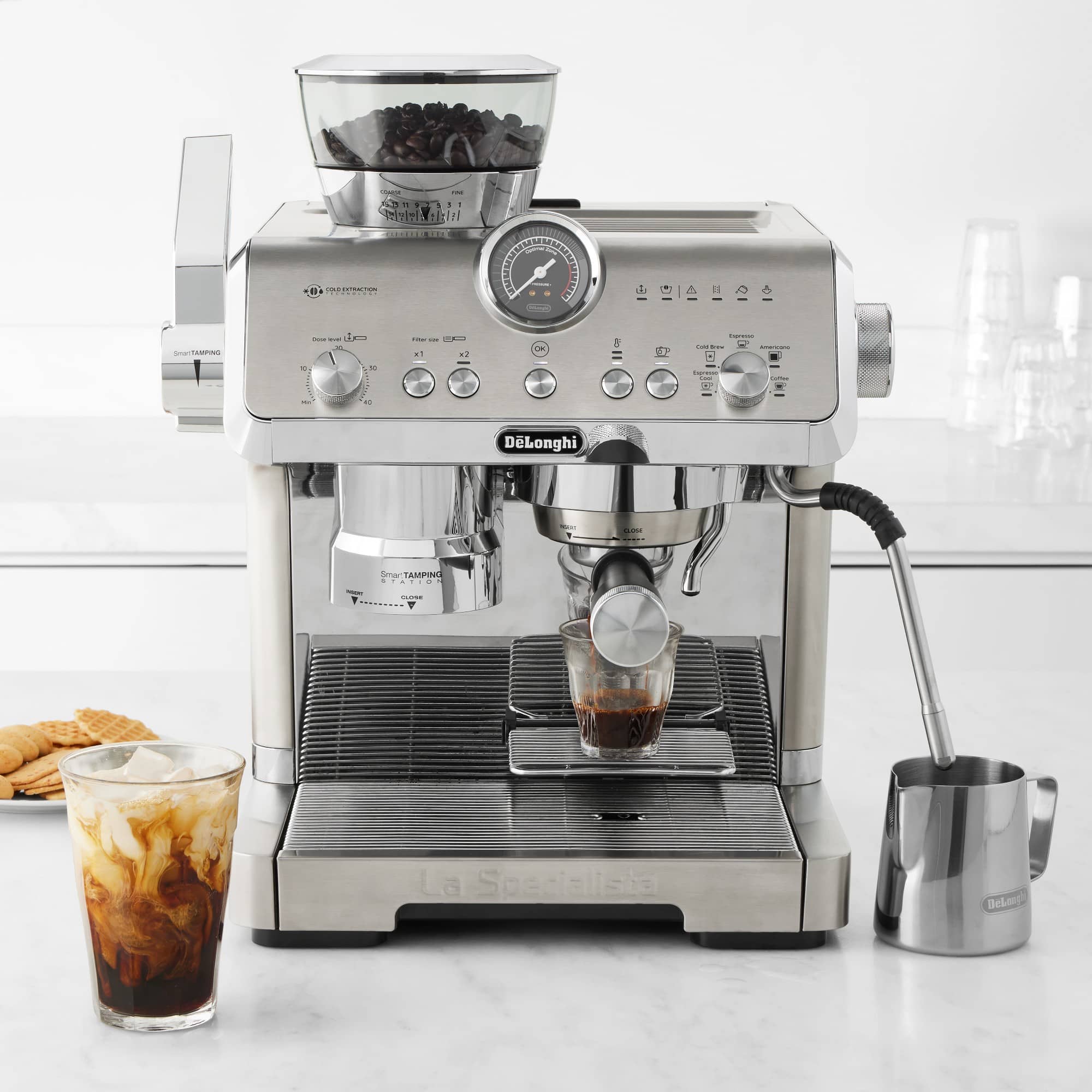 Stainless espresso machine with cold brew glass under portafilter and metal jug