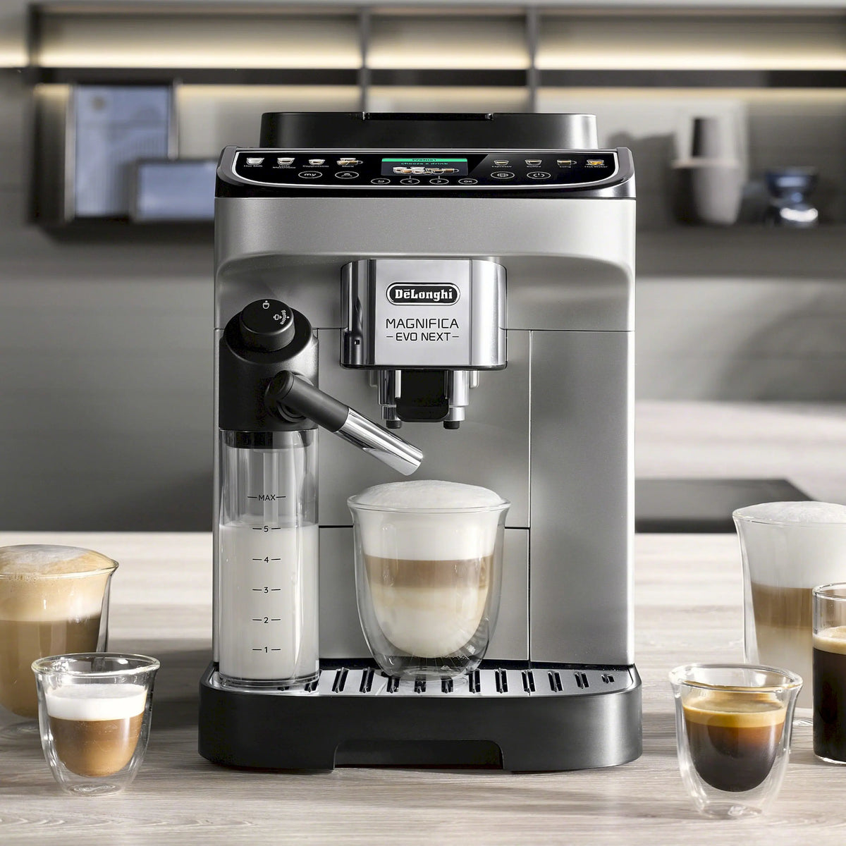 Fully automatic espresso machine on countertop with several filled cups, stainless and black.