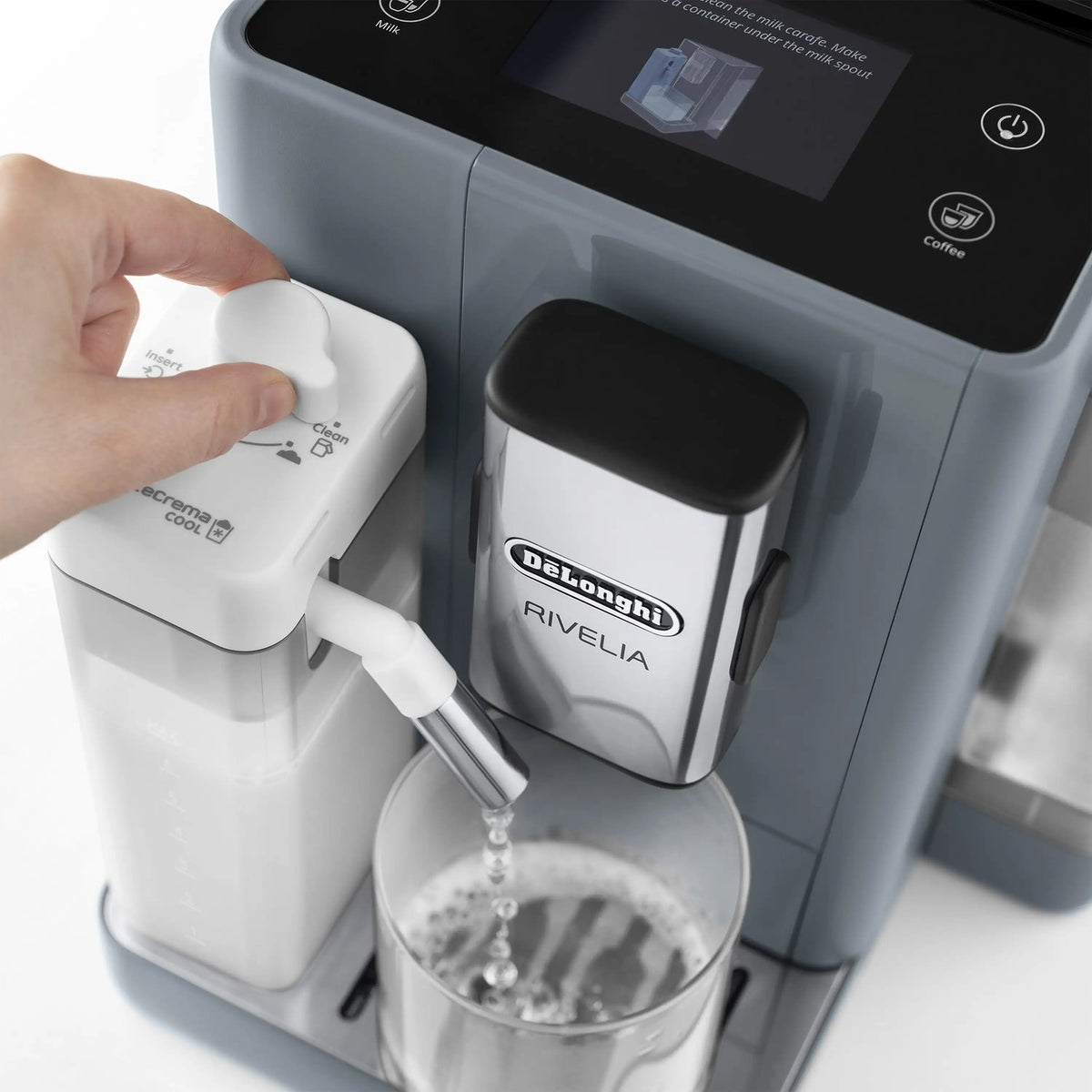 Hand attaching the white LatteCream Cool accessory to an espresso machine spout