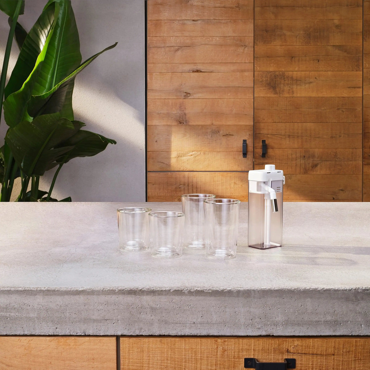 White accessory dispensing into empty clear cups on a countertop