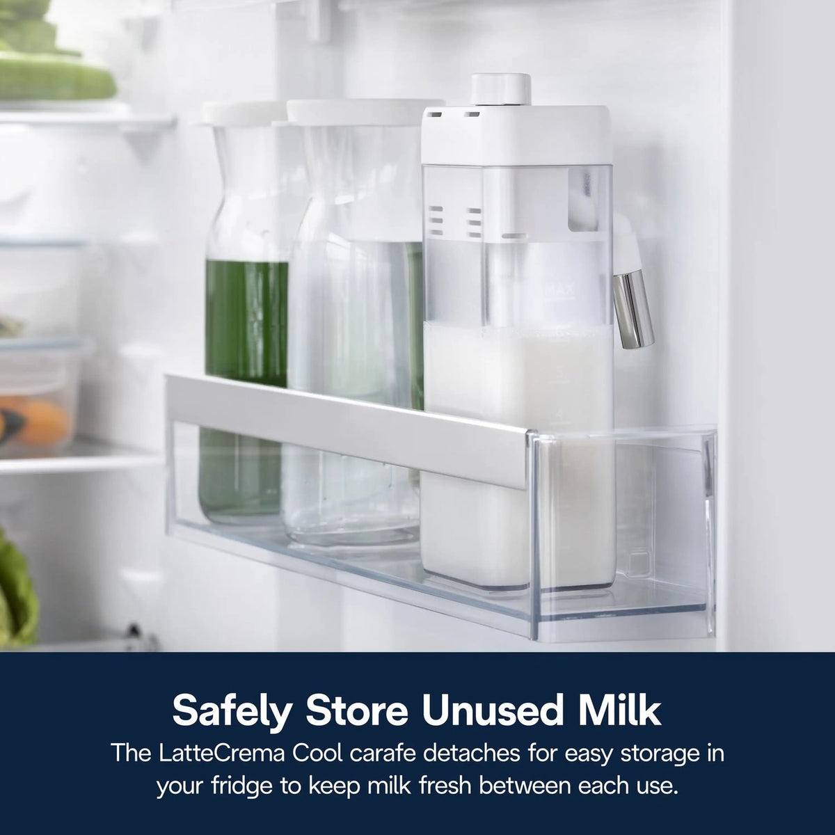 Milk storage carafe in clear compartment with frothing nozzle