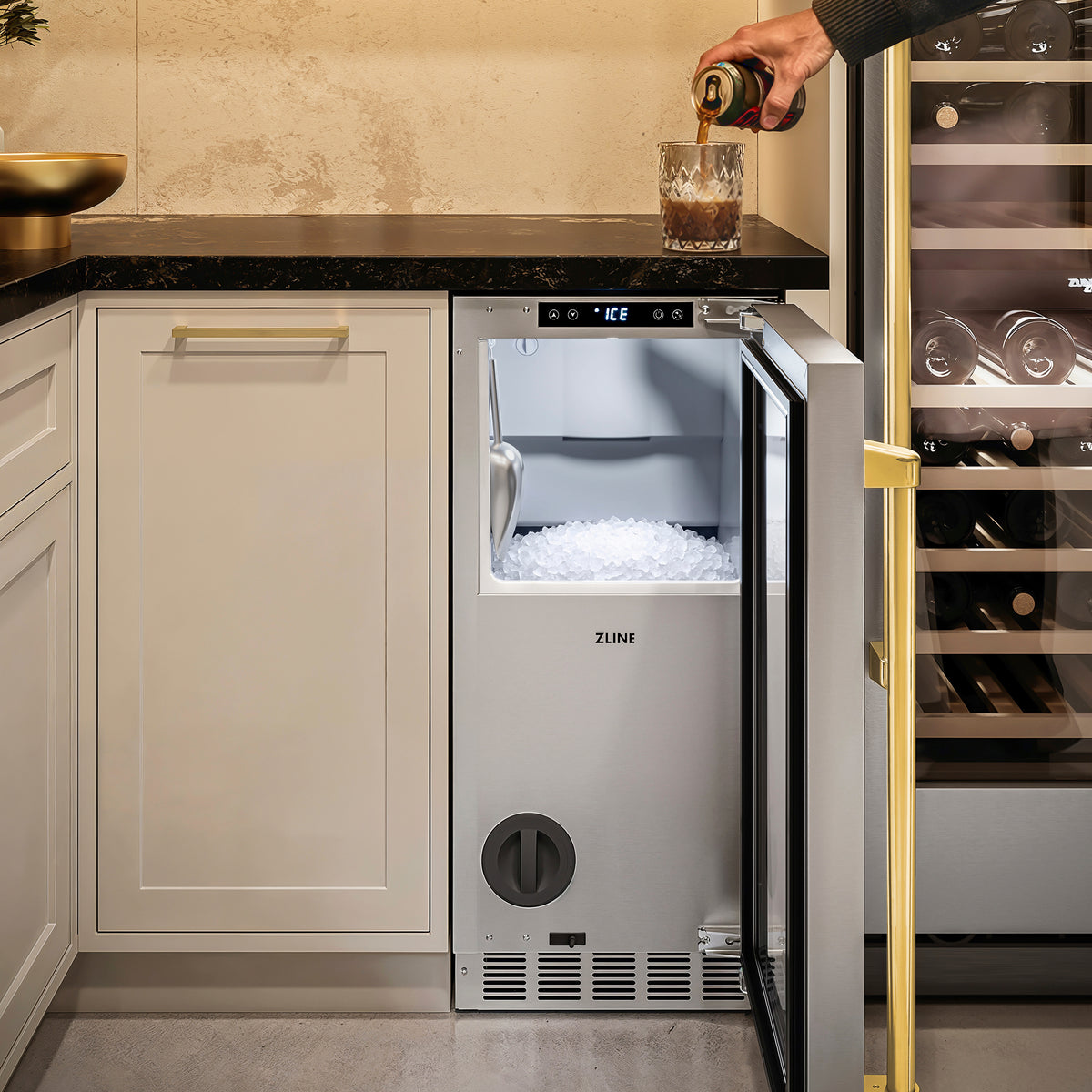 Filling a glass with nugget ice from the ZLINE Autograph Edition ice maker in a cellar nook (INGDZ-ST-15-G)