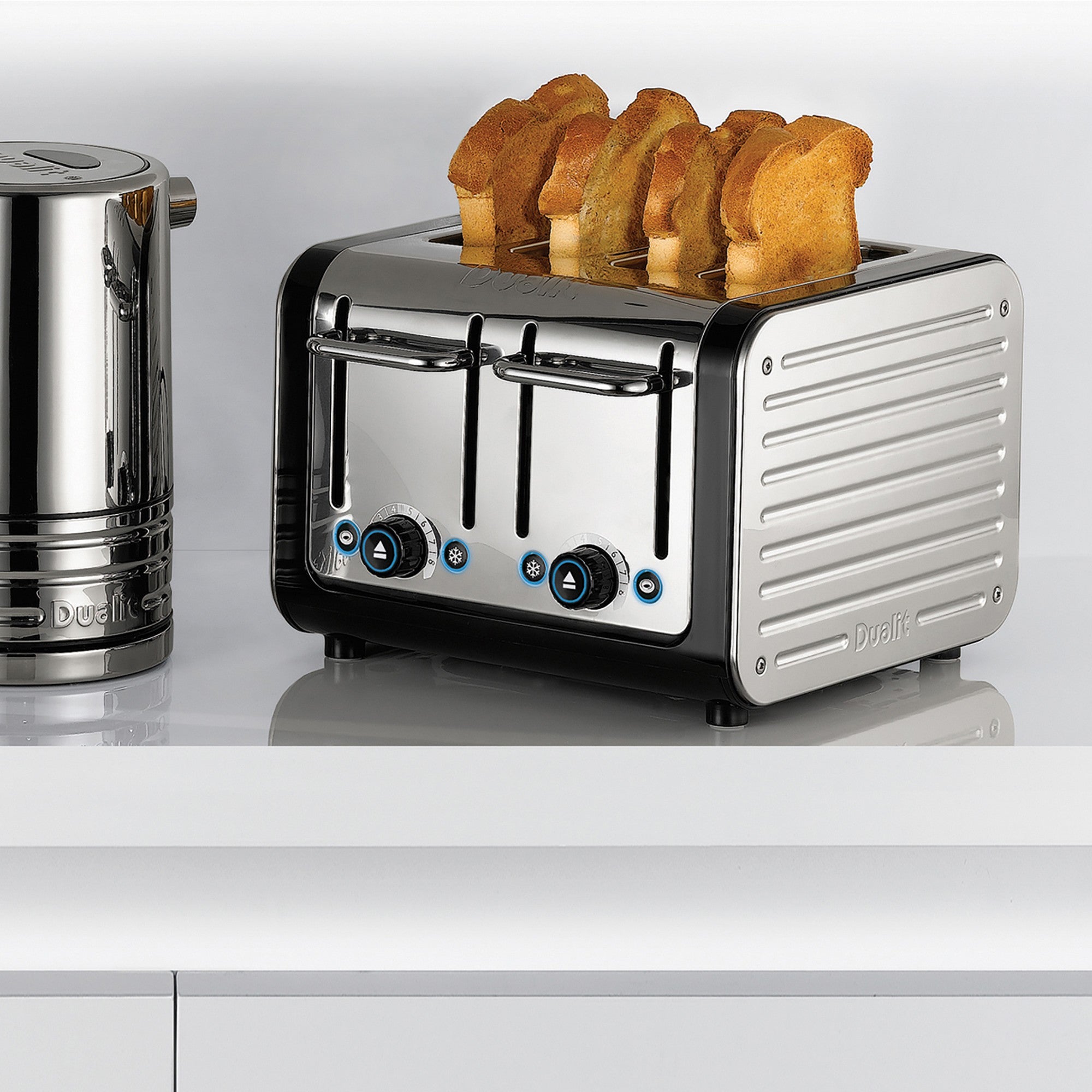 Stainless steel 4-slice toaster with bread rising from the slots, front view.