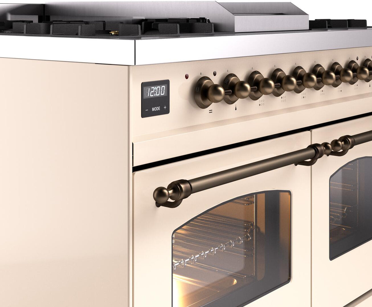 Antique white dual fuel range control panel with bronze knobs and left oven door window