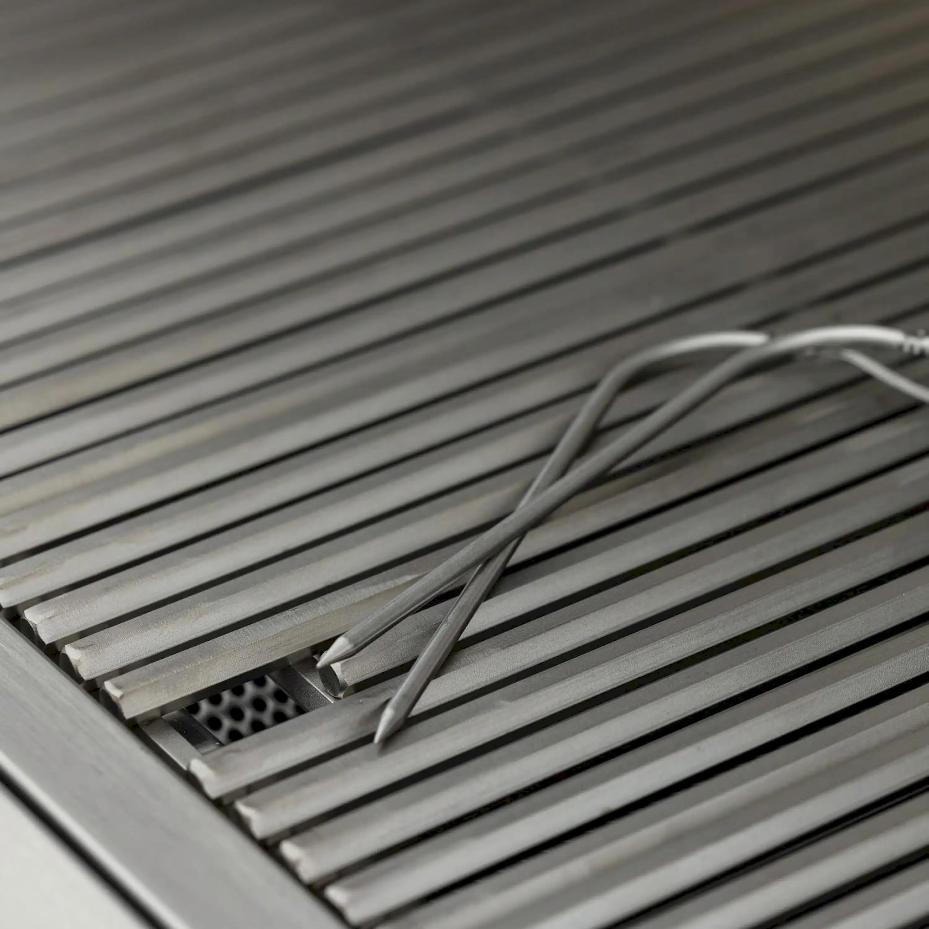 Stainless steel grill burner grates with ignition wire across the rails
