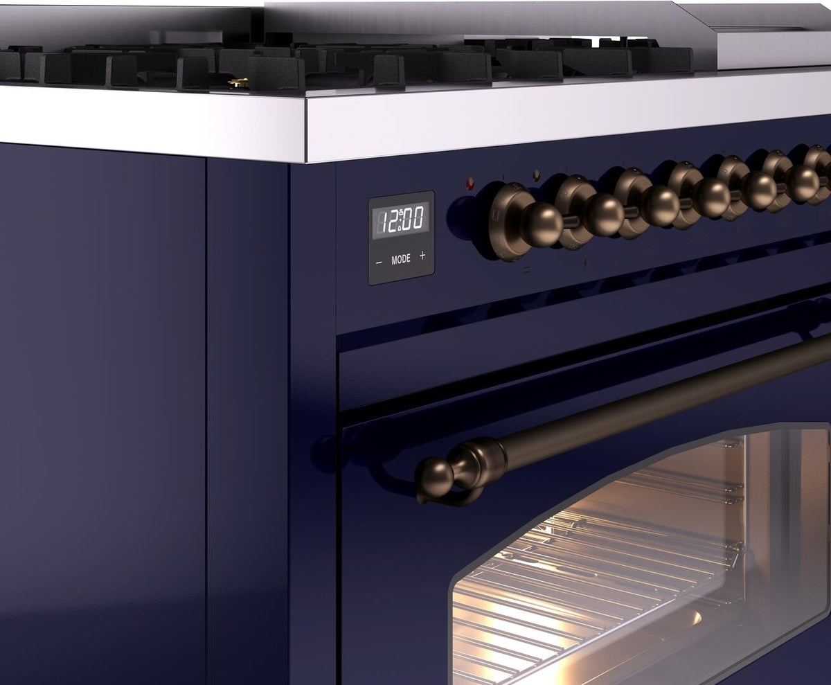 Midnight blue dual fuel range with bronze control knobs and open oven door