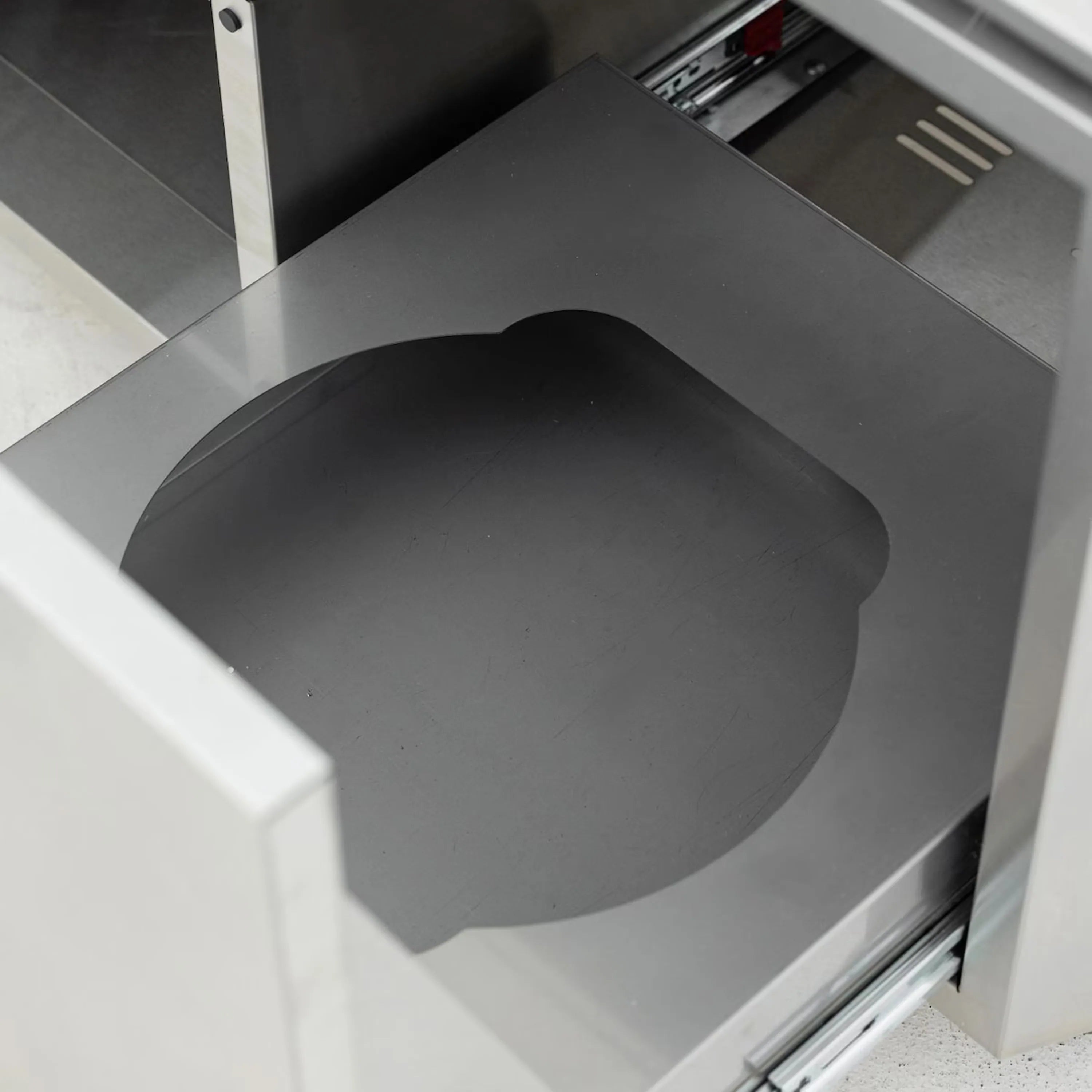 Outdoor oven cart interior with metal cooking chamber and angled rear vent openings
