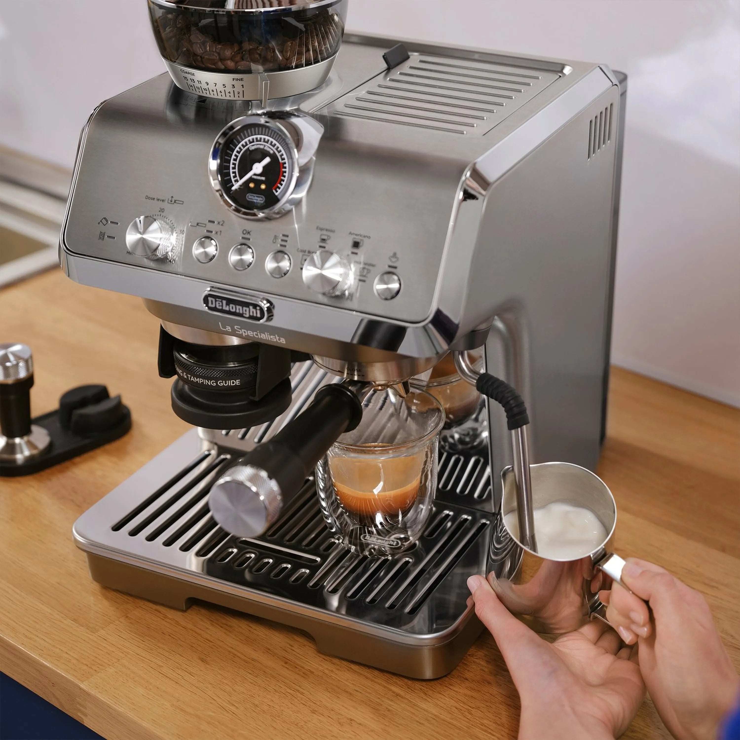 Stainless espresso machine with portafilter and hand adjusting coffee cup