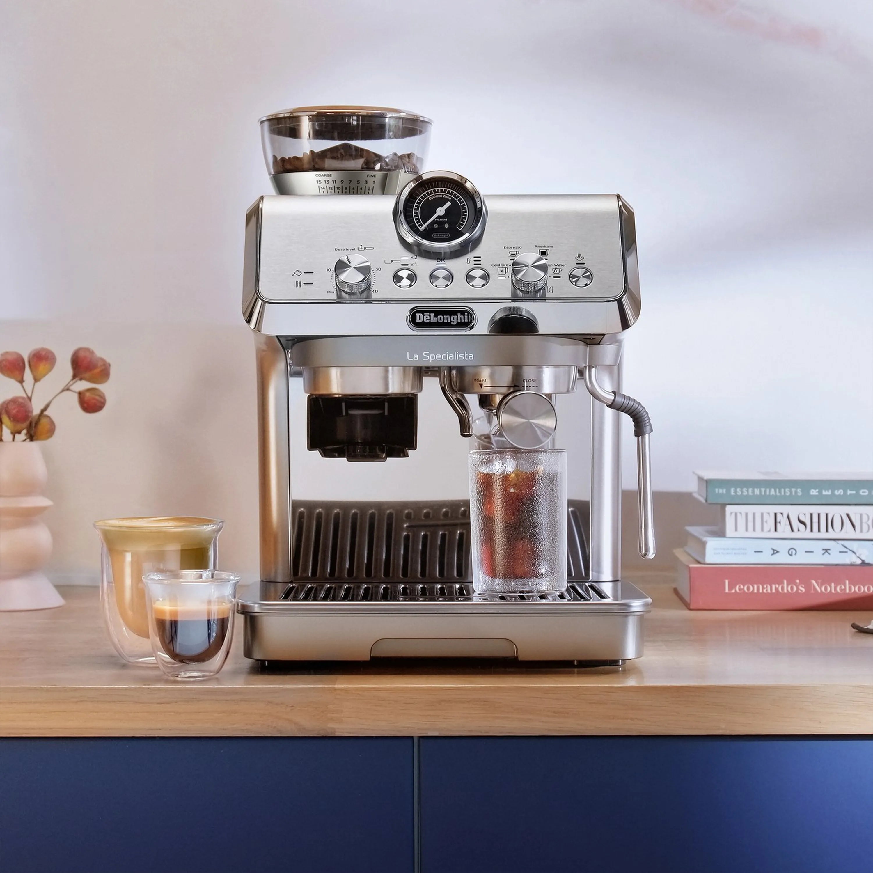 Stainless espresso machine with cold brew cups and portafilter, countertop front view.