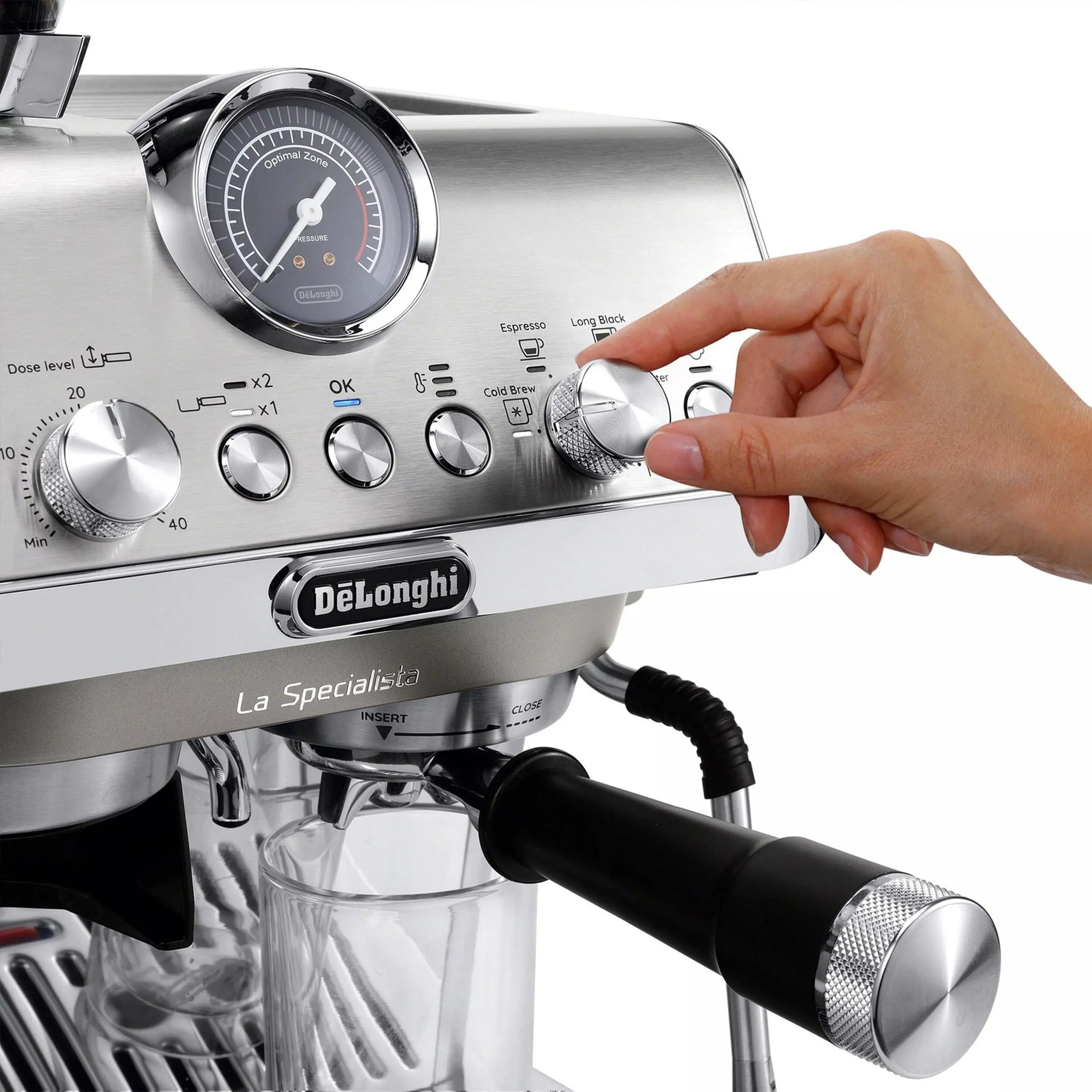 Close-up of stainless espresso machine control dial and hand adjusting settings.