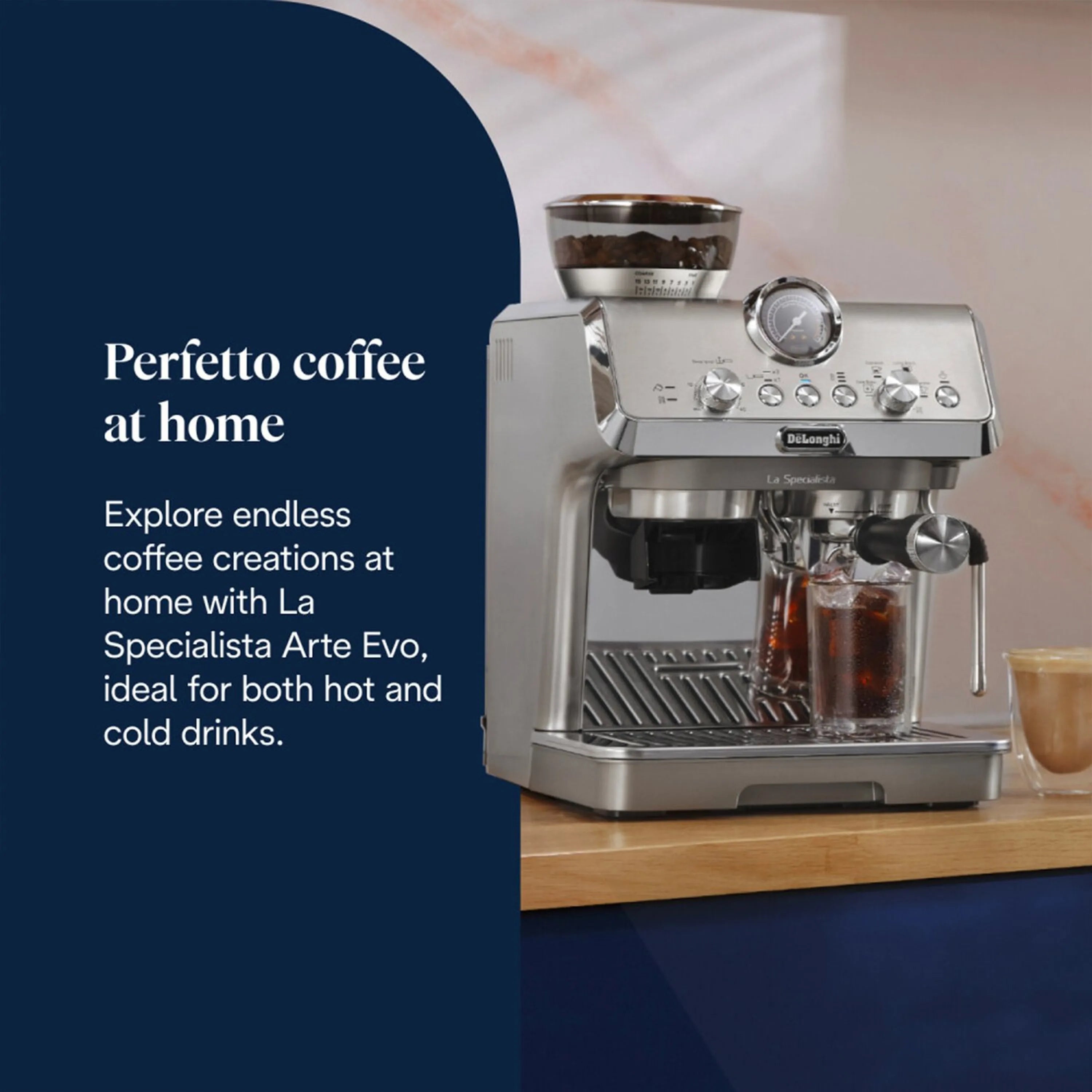 Stainless espresso machine with cold brew container and glass cup on countertop