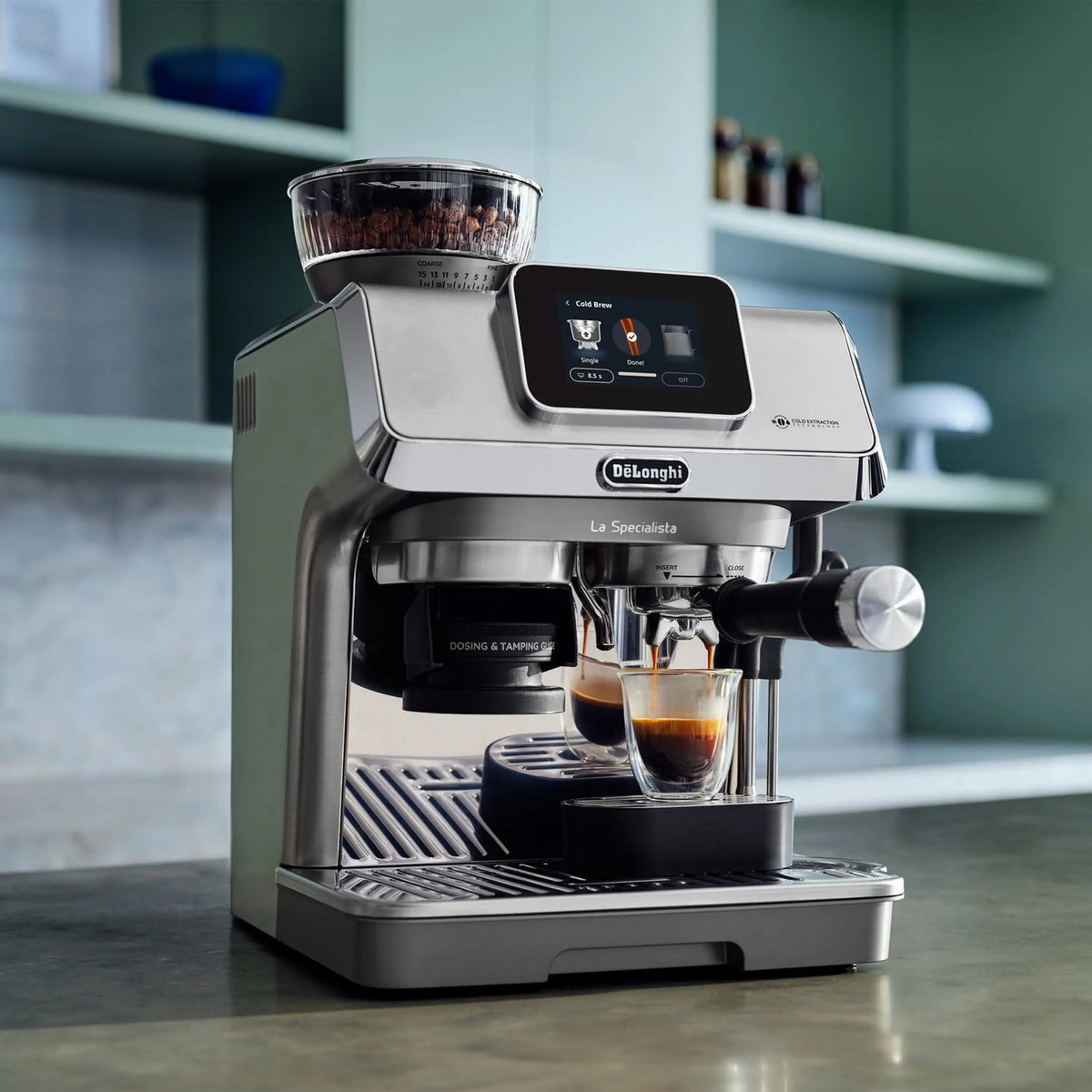 Espresso machine side close-up with tamper-style handle and two cups