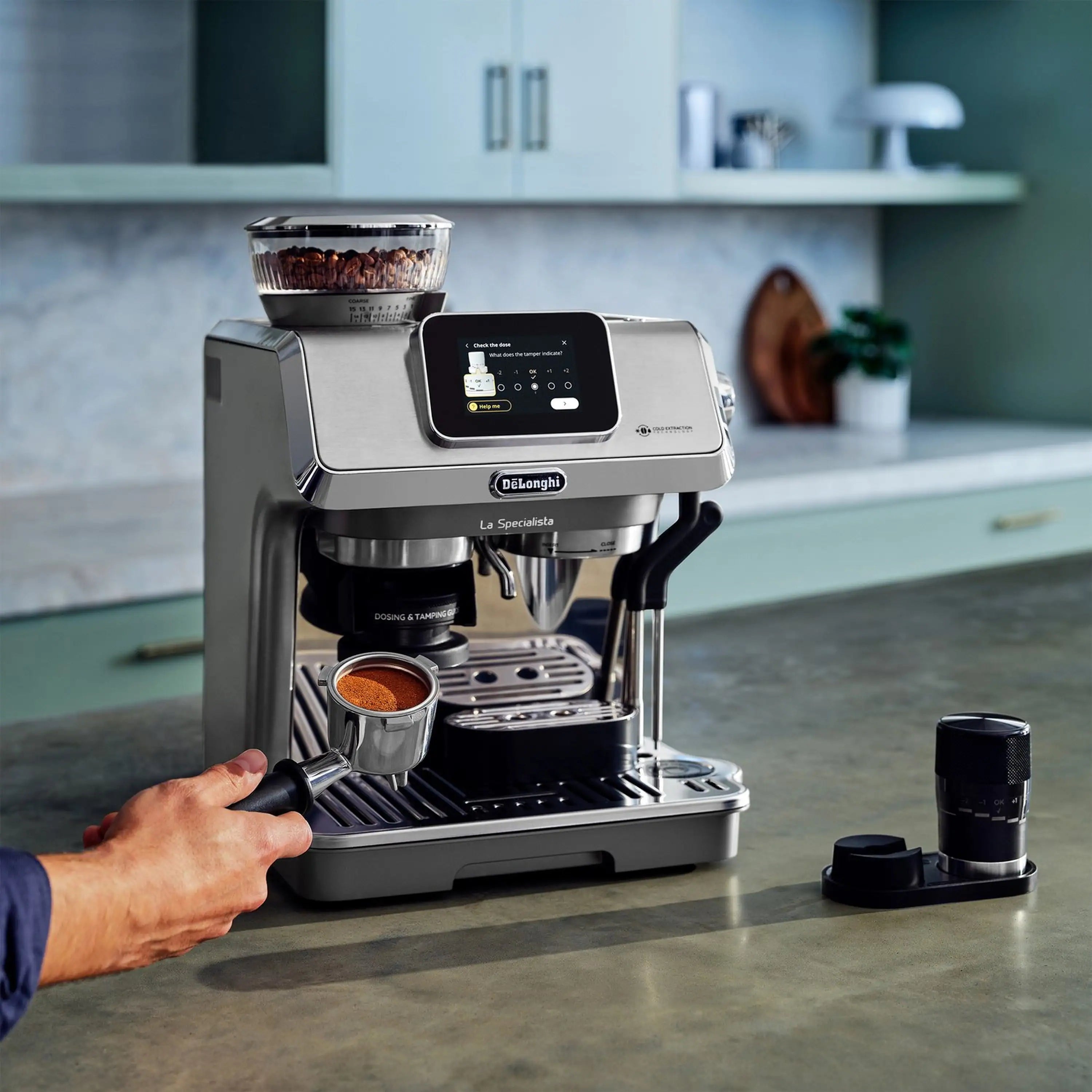 Stainless espresso machine with touch display and cup under portafilter spout